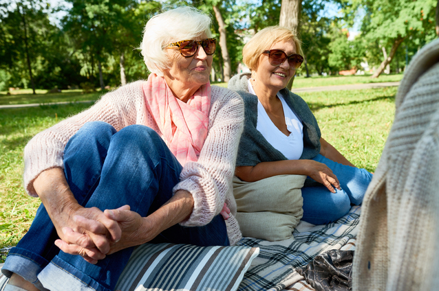 Two elderly women enjoying time outdoors.