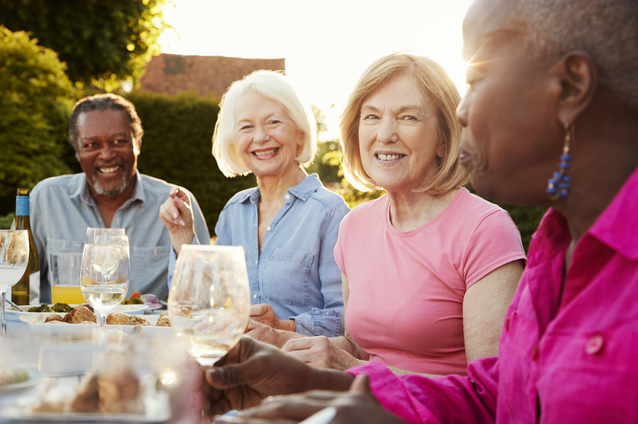 Residents enjoying a meal outdoors together.