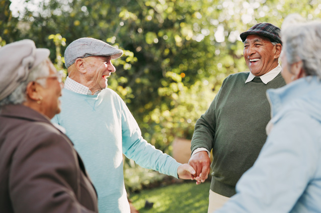 Seniors enjoying a joyful moment in a garden.