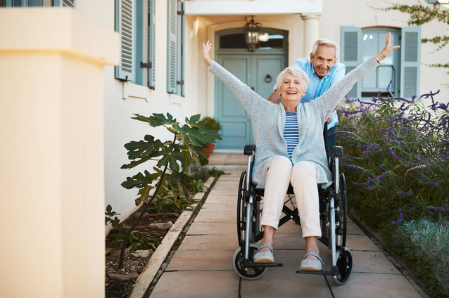 Happy resident in a wheelchair enjoying the outdoors