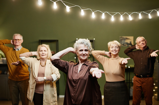 Seniors participating in a joyful activity indoors.
