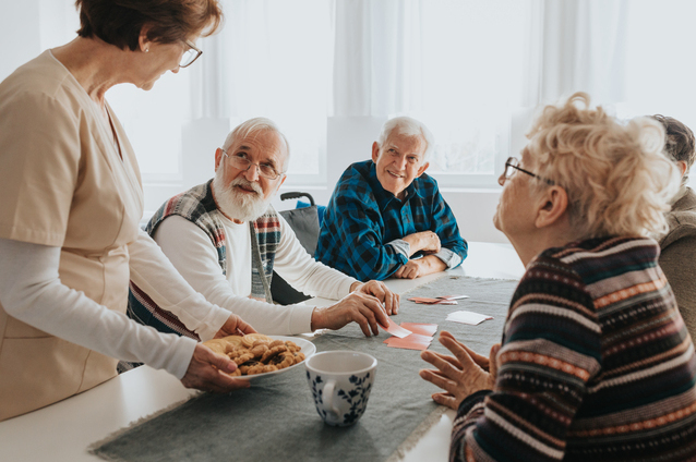 Residents engaged in an activity with a staff member.