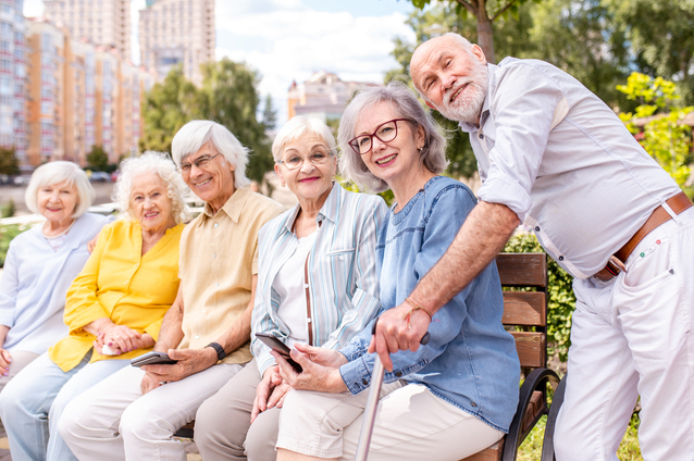 Seniors enjoying time outdoors on a bench