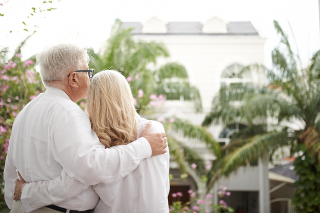 Couple embracing in a lush outdoor space