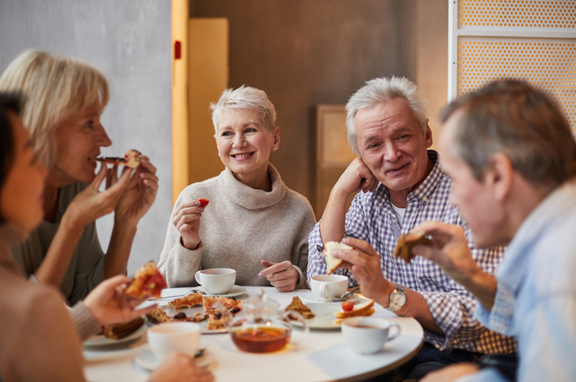 Group of seniors enjoying snacks and conversation
