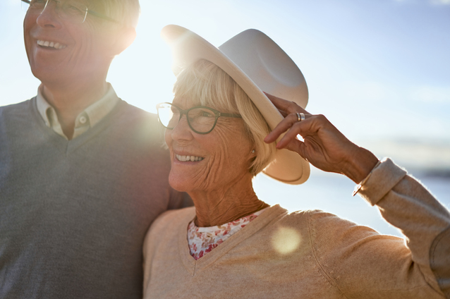 Smiling senior woman outdoors with a younger man