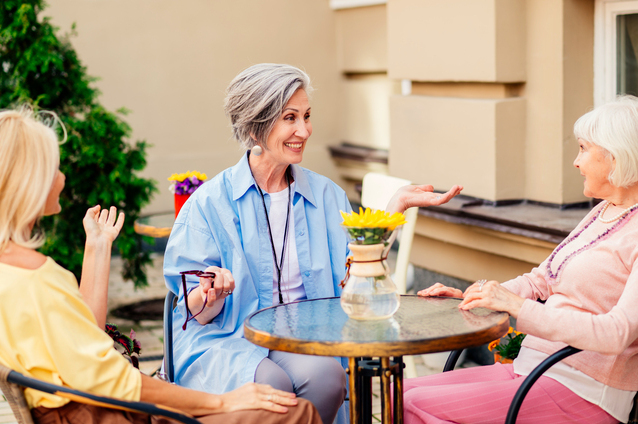Residents enjoying conversation in an outdoor space.