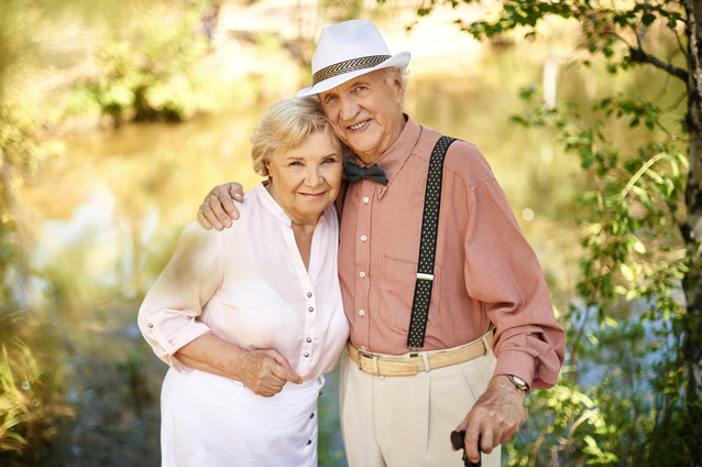 Happy senior couple outdoors by the water