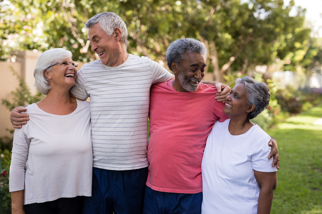Four smiling seniors enjoying time outdoors