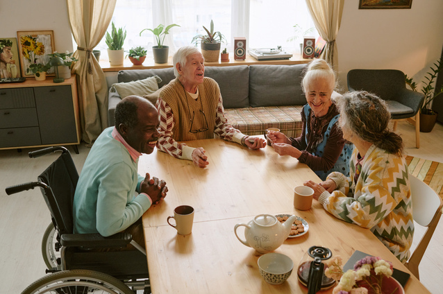 Residents enjoying time together at a communal table.