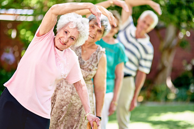 Seniors participating in a stretching exercise outside