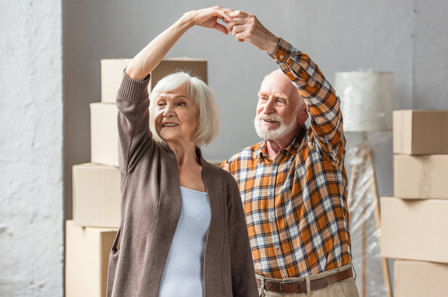 Happy elderly couple dancing together.