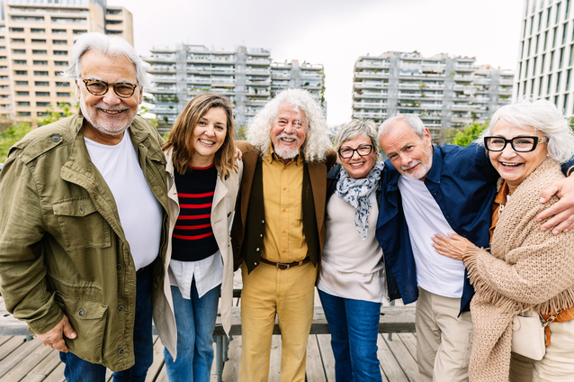 Group of happy seniors outdoors at a facility