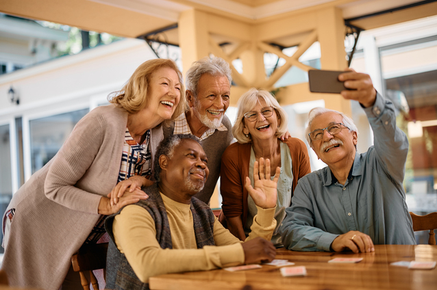 Residents enjoying a fun group selfie indoors.