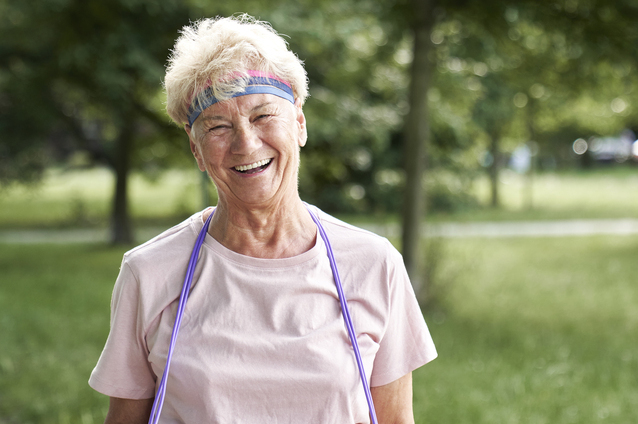 Smiling senior woman outdoors wearing exercise gear