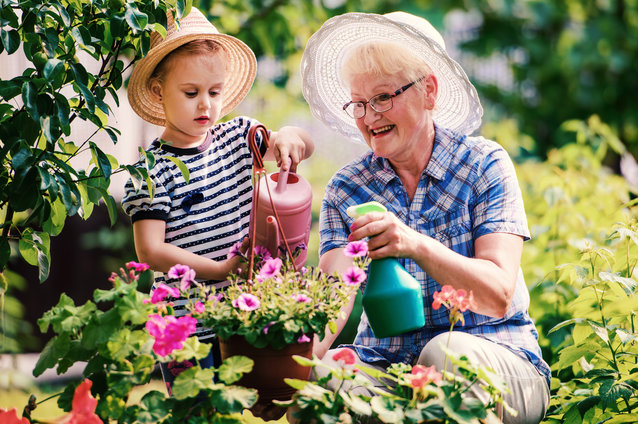 Elderly woman gardening with a child