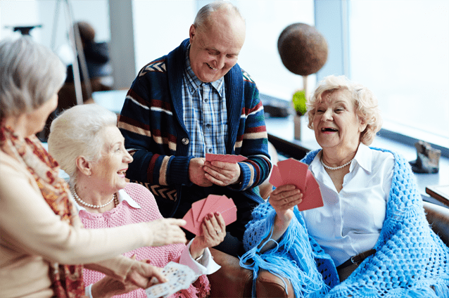 Residents playing cards in a lively common area