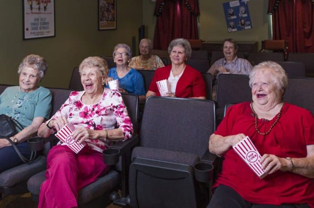 Residents enjoying a movie with popcorn