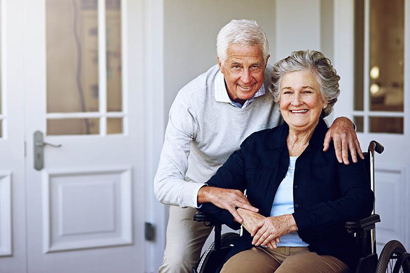 Senior couple smiling together in a care facility