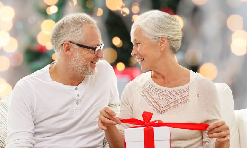 Happy couple exchanging a gift during a celebration