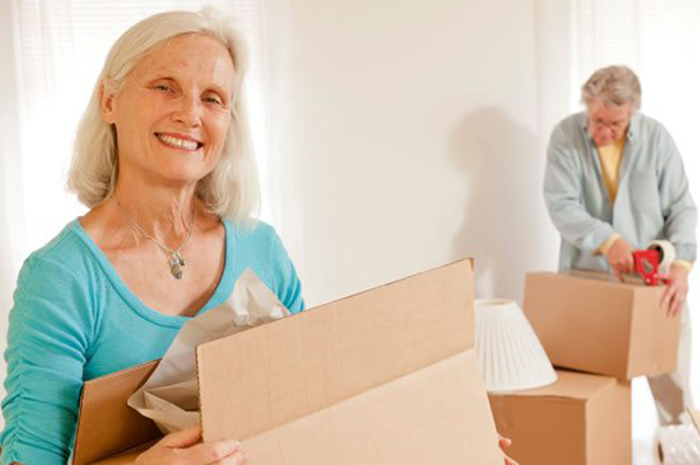 Residents unpacking boxes in a warm interior