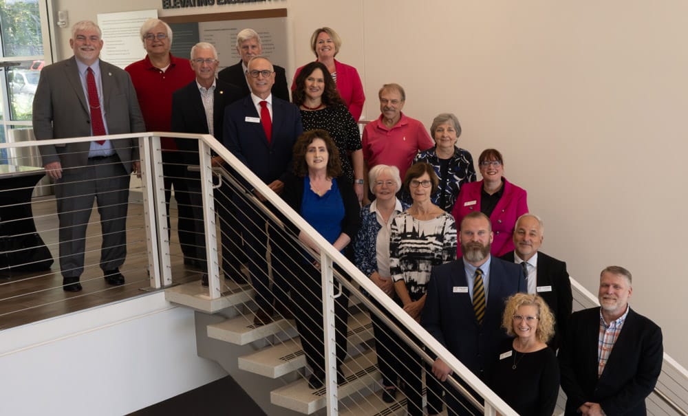 Group photo of staff in a staircase area.