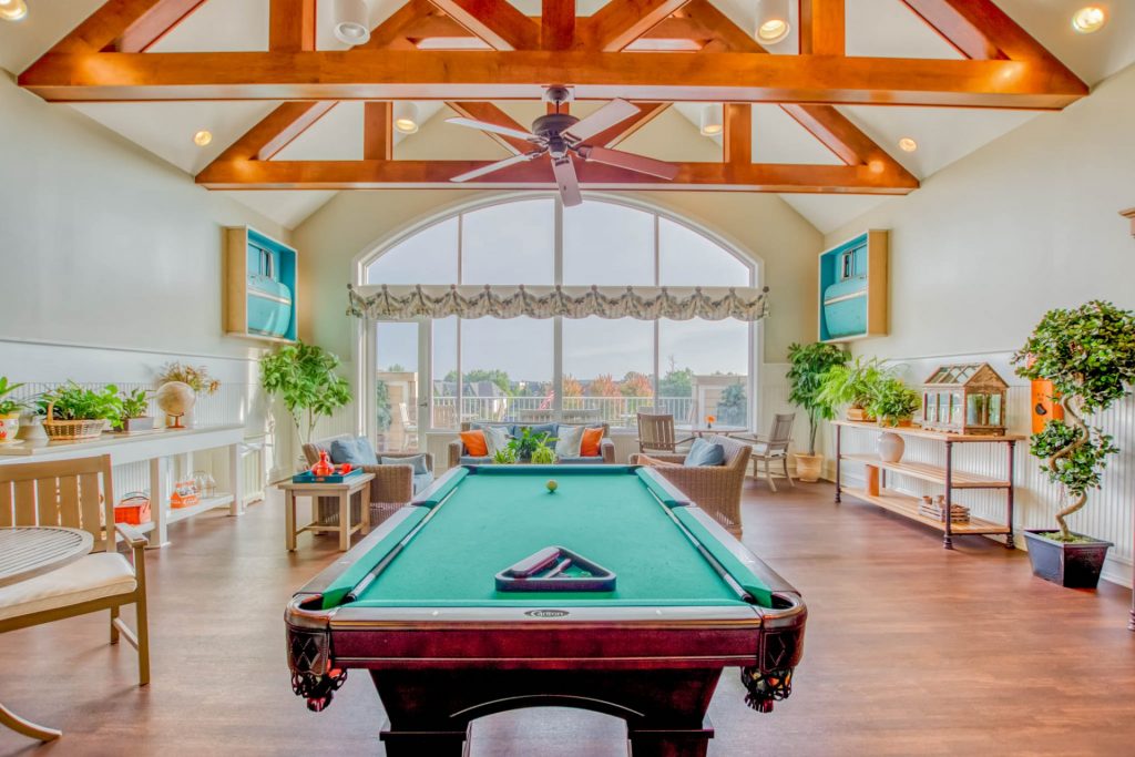 Bright common area with a pool table and seating