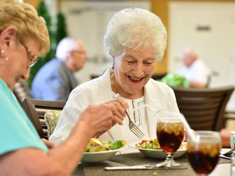 Residents enjoying a meal together in the dining area