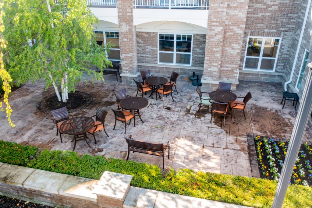 Outdoor patio seating area with tables and chairs.