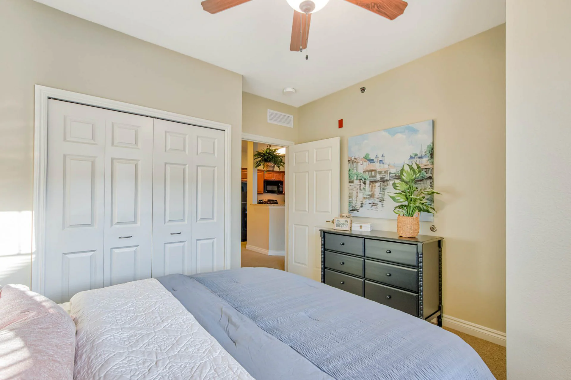 Cozy interior of a resident's room with a bed and dresser.