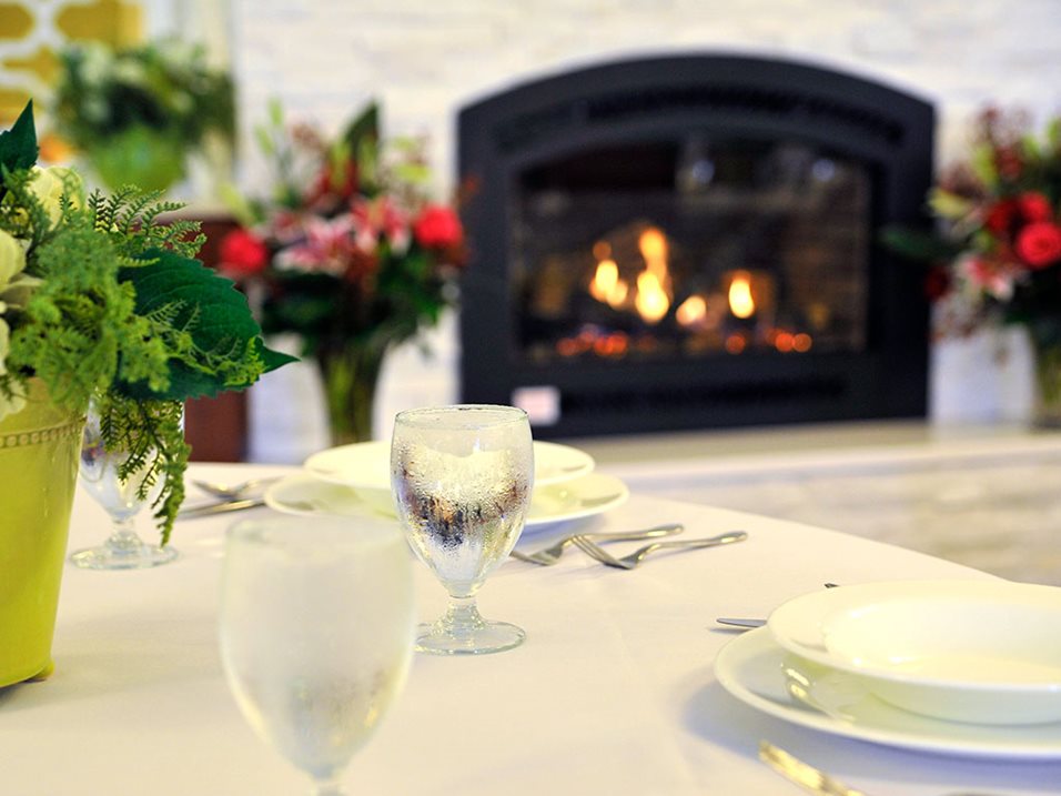 Dining table set near a cozy fireplace