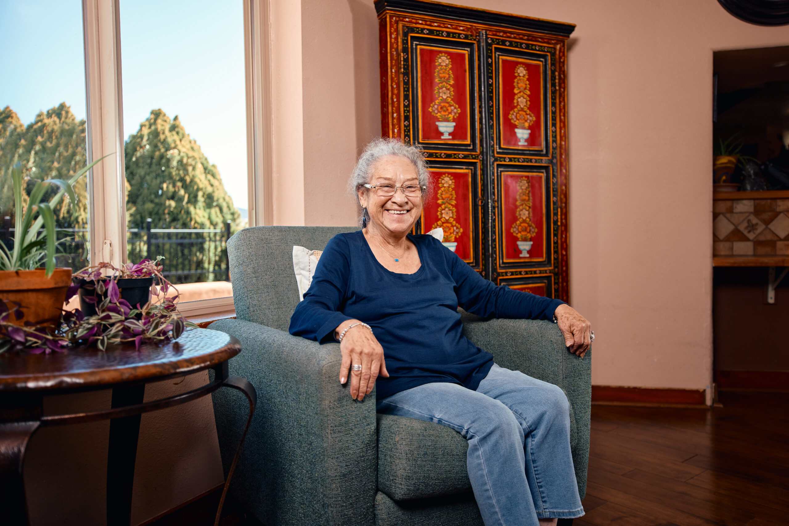 Smiling senior woman sitting in a cozy chair.