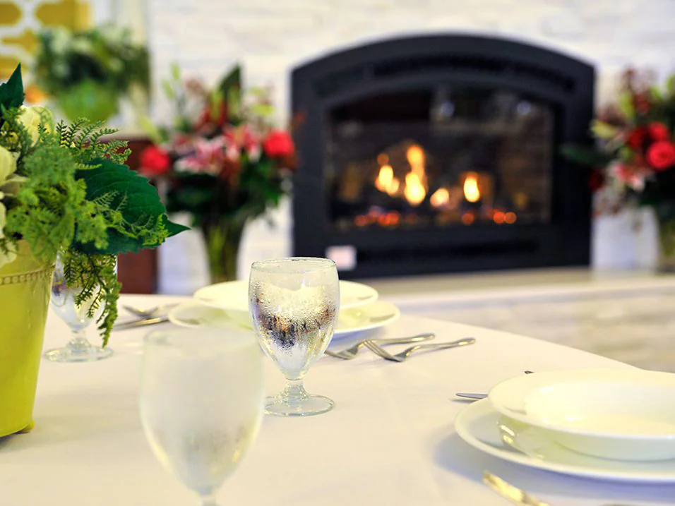 Dining setting with dishes and a cozy fireplace