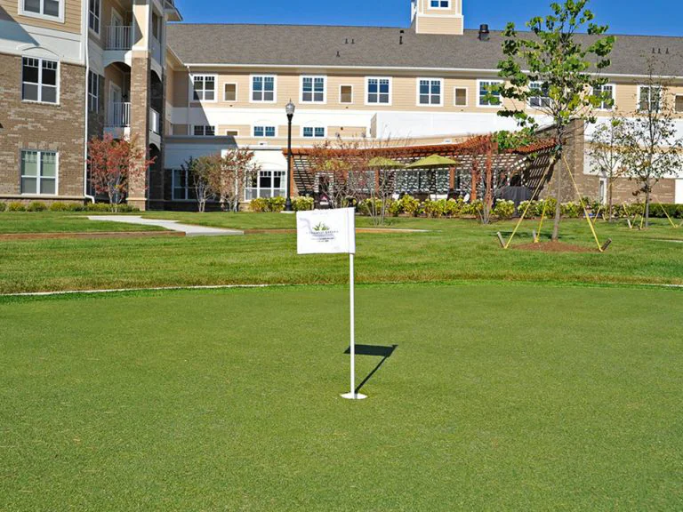 Outdoor space with a flag and building in the background.