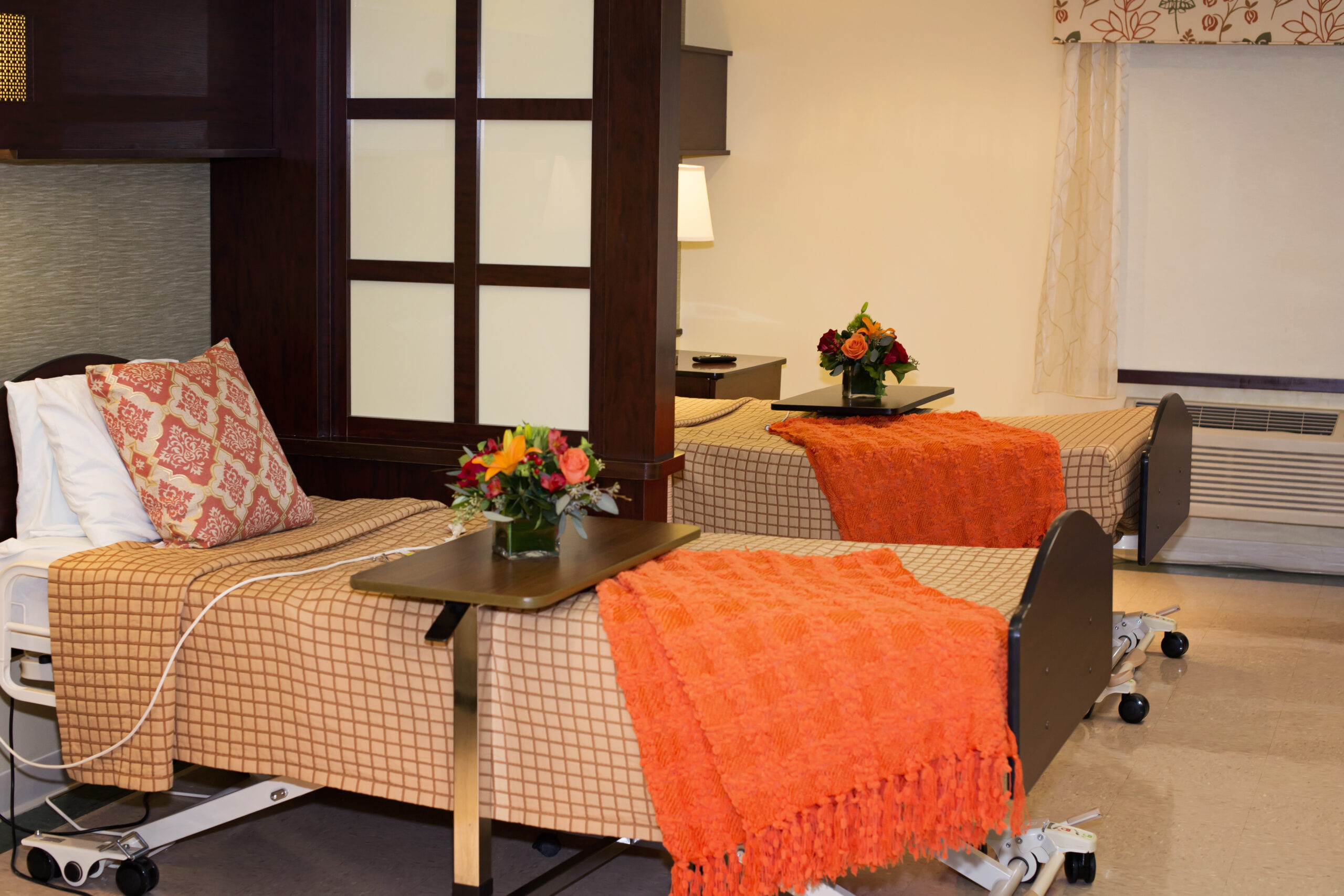 Cozy resident room with floral decor and warm blankets.