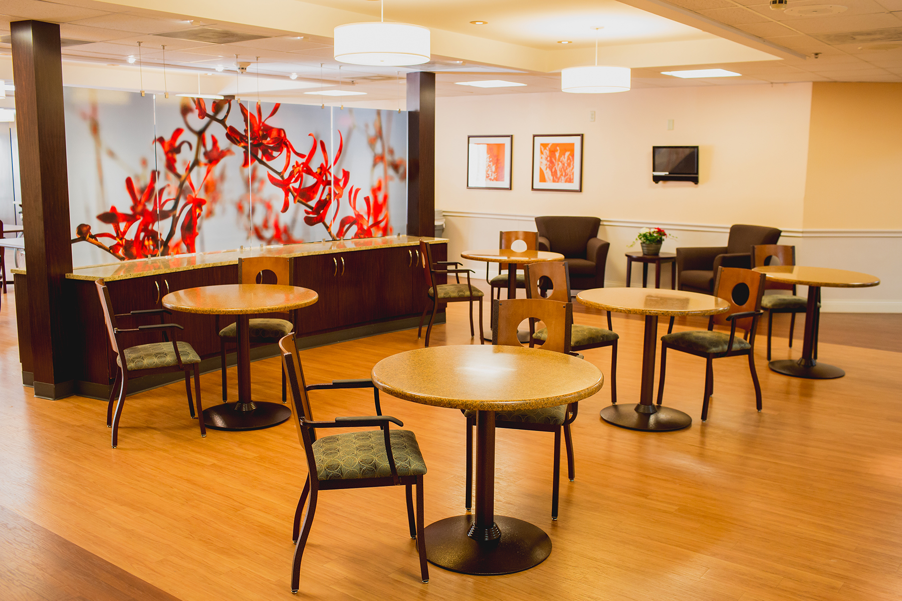 Bright common area with round tables and chairs
