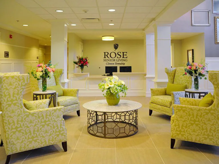 Bright lobby area with floral decor and comfortable seating.