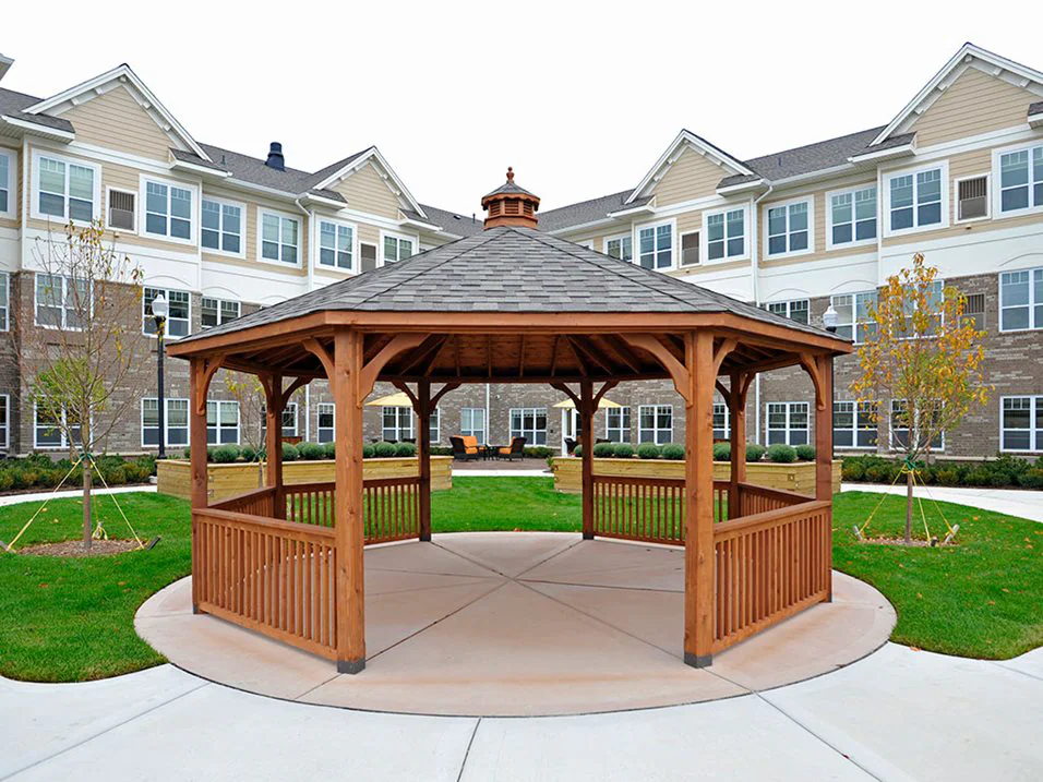Wooden gazebo in a landscaped courtyard