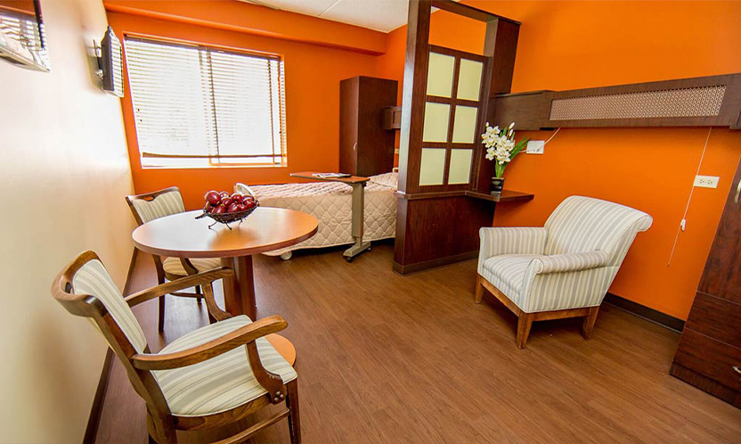 Private resident room with orange walls and furniture