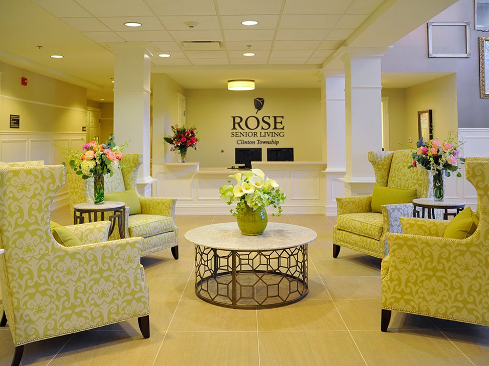 Bright interior lobby with floral arrangements and seating.