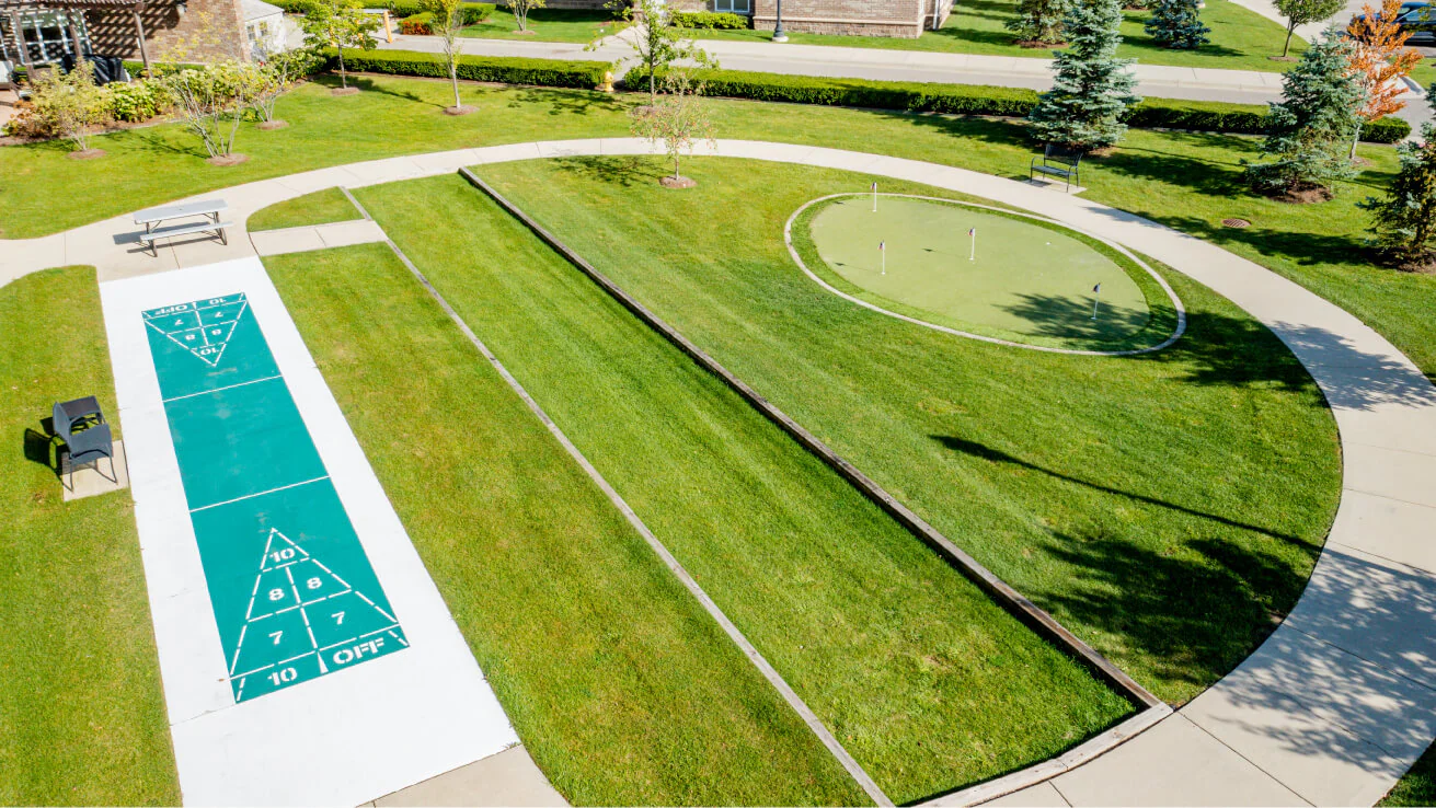 Outdoor recreational area with games and green space.