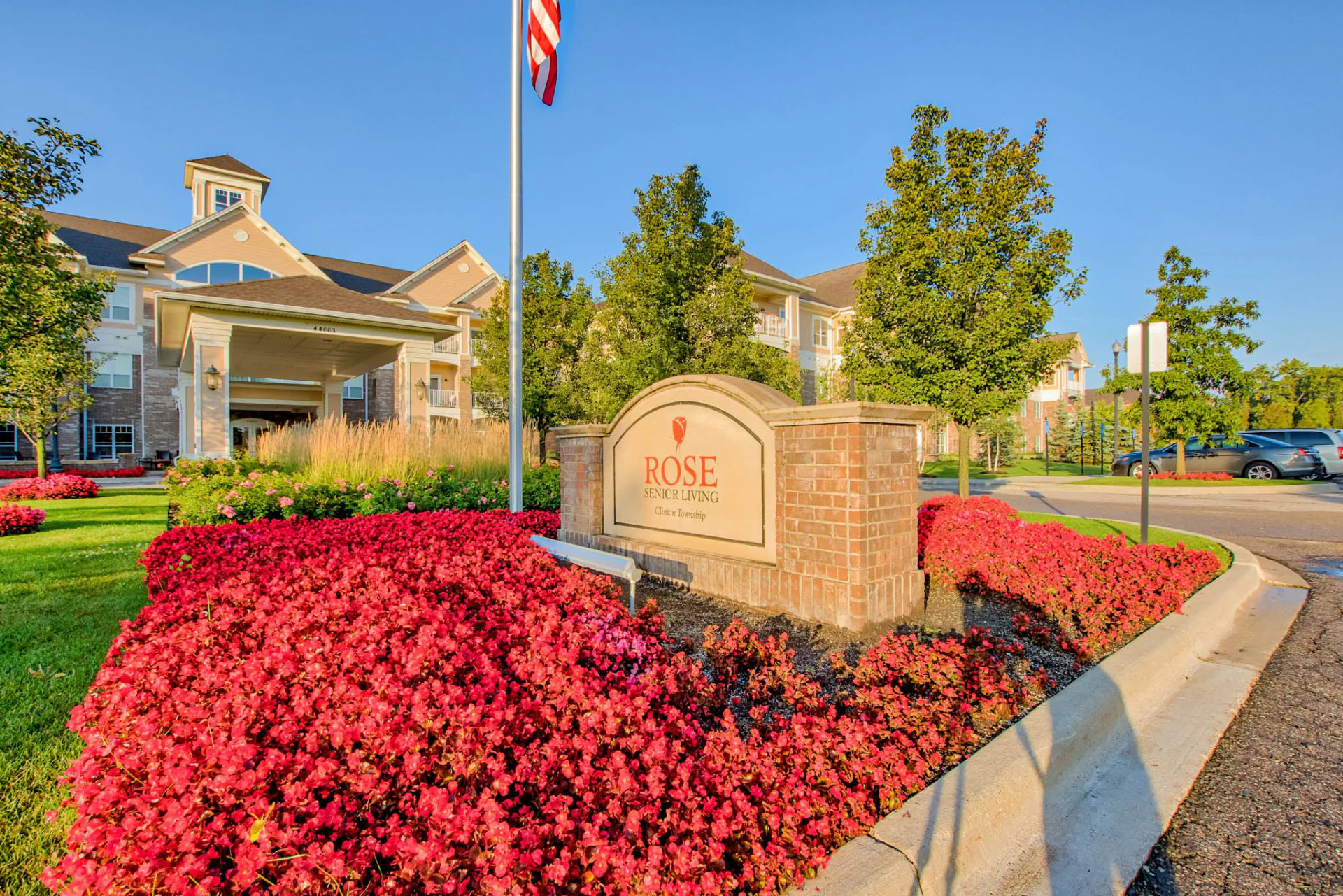 Exterior view of Rose Senior Living with flowers.