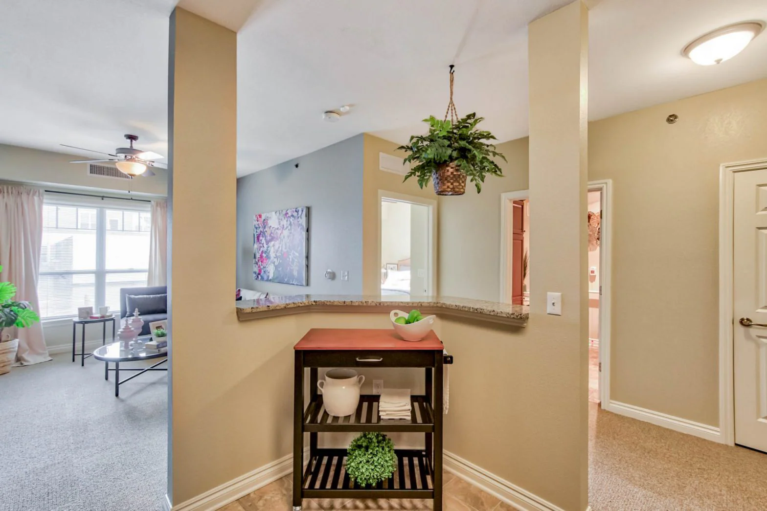 Interior view of a common area with plants and decor.