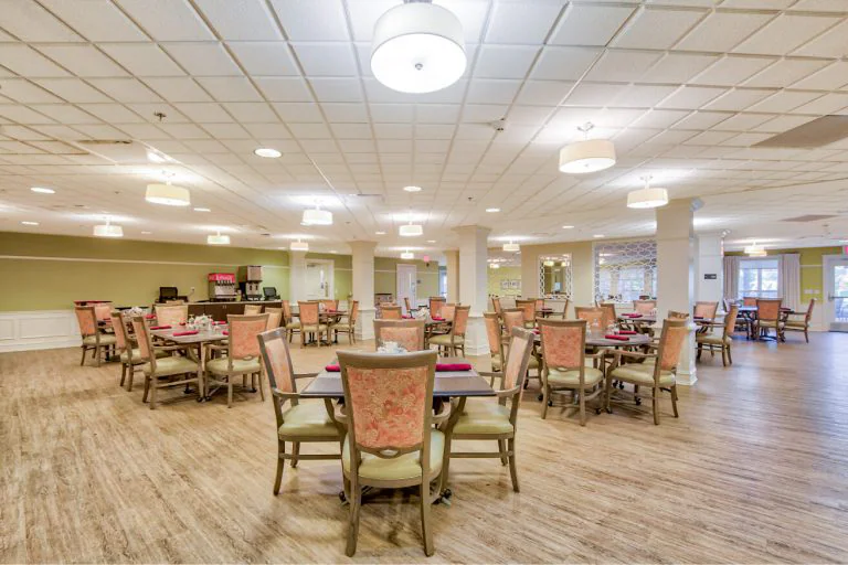 Dining area with tables and chairs set up.