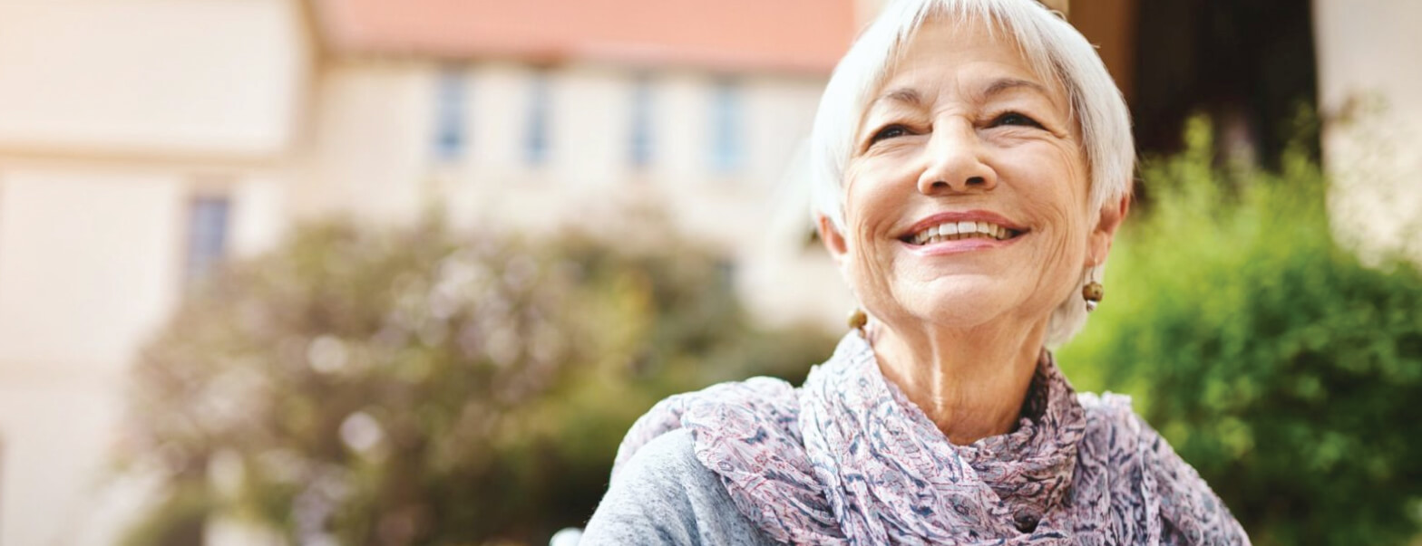 Smiling elderly woman enjoying outdoor space