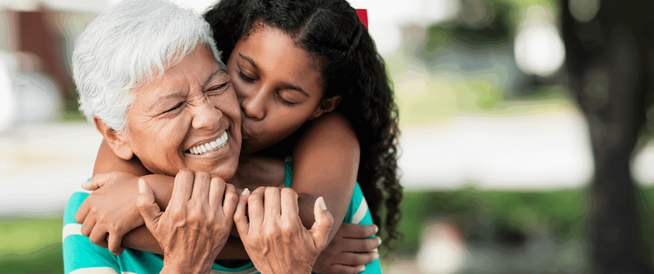 Elderly woman with young girl enjoying a moment together.