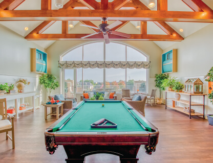 Bright common area with a pool table and seating.