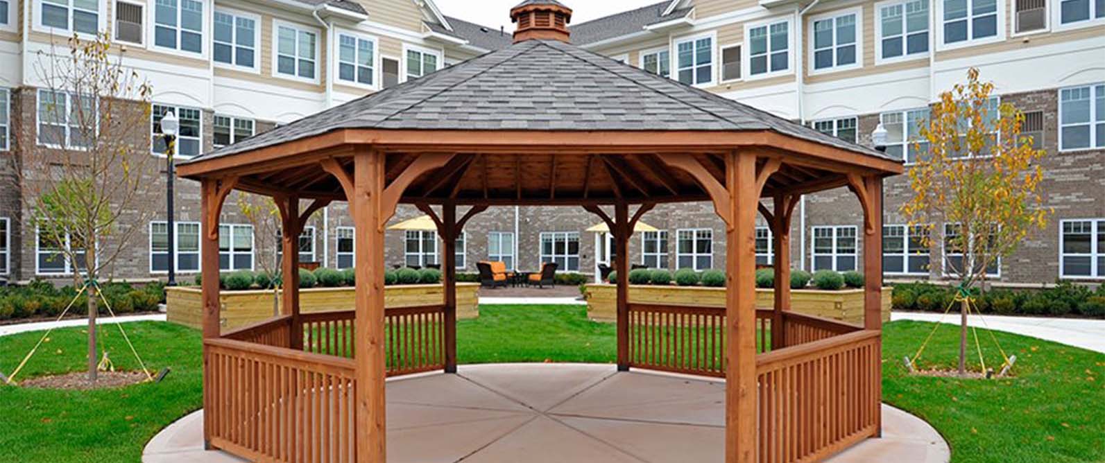 Wooden gazebo in landscaped outdoor area