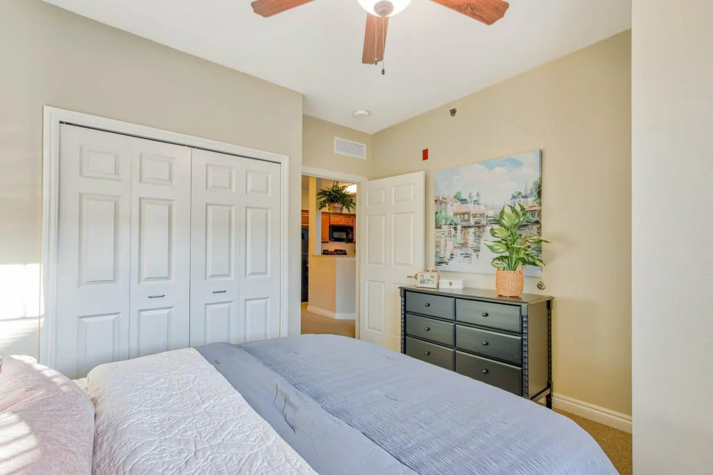 Well-furnished bedroom with closet and artwork