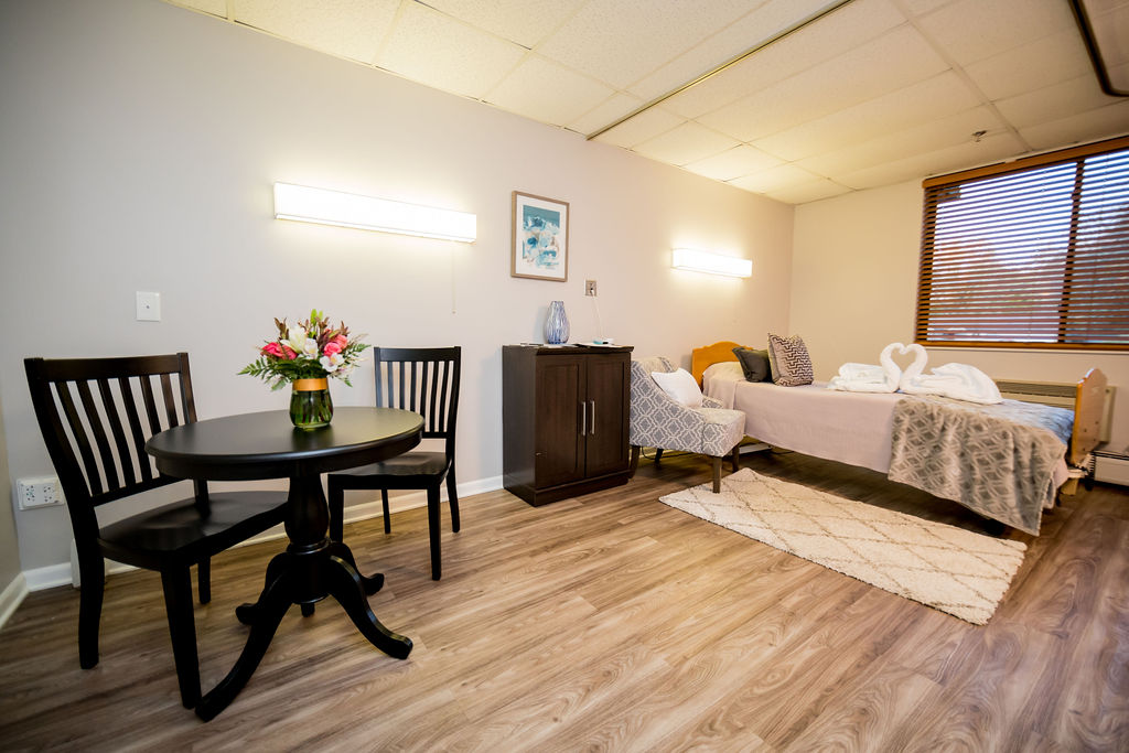 Cozy private resident room with a table and flowers